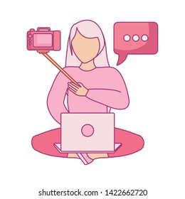 woman seated using laptop computer with photographic camera