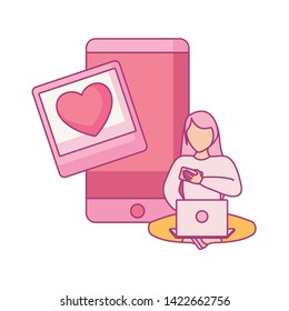 woman seated using laptop computer with smartphone