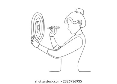 A woman shoots an arrow at the target board. Achieve target at work
