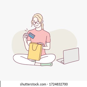 Woman shopping online on laptop. Hand drawn style vector design illustrations.