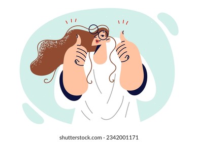 Woman shows thumbs up as sign confirming high quality of your company services or products. Young girl with glasses approvingly demonstrates thumbs up supporting new bill from government