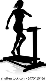 A woman in silhouette using a treadmill running machine piece of gym fitness equipment 