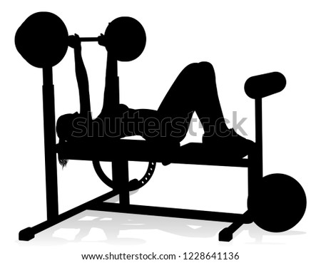 A woman in silhouette using weights bench and barbell fitness exercise gym equipment 