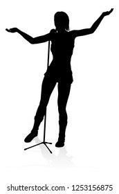 A woman singer pop, country music, rock star or even hiphop rapper artist vocalist singing in silhouette