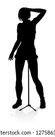 A woman singer pop, country music, rock star or even hiphop rapper artist vocalist singing in silhouette