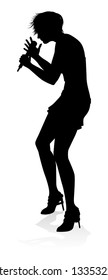 A woman singer pop, country music, rock star or even hiphop rapper artist vocalist singing in silhouette