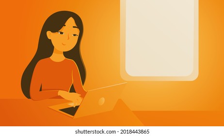 woman sit and work on a table in the evening time in orange and yellow atmosphere.