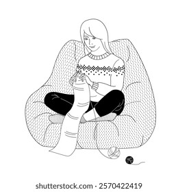 woman sits in a chair and knits a scarf