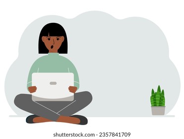 A woman sits cross-legged in his hands holding a laptop. The concept of work, education, reading, watching videos.