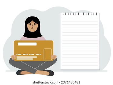 A woman sits cross-legged in his hands holding a large credit card next to a close-up notepad for text. Concept of credit card, expense planning, income planning.