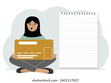 A woman sits cross-legged in his hands holding a large credit card next to a close-up notepad for text. Concept of credit card, expense planning, income planning.