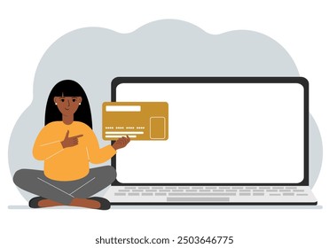 A woman sits cross-legged and holds a large plastic card. Next to the woman is a large laptop with space for text.