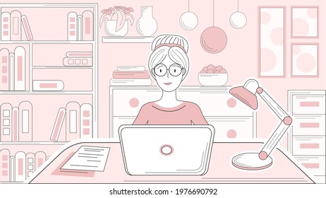 Woman sits in front of the computer in a cozy pink line interior. Laptop and lamp are on the table and behind there is a bookcase, two cupboards, books, pictures on the wall and a plant on the shelf.
