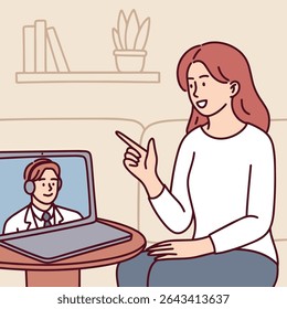 Woman sits at home pointing and talking to child on laptop screen during remote video call, communicating with family online