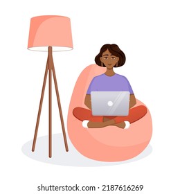 Woman sits on the bean bag chair and works at the computer. Remote work, office at home, programming, freelance. Study at home in quarantine. Vector illustration.