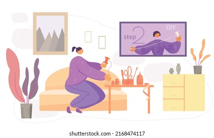 A woman sits in a room and repeats the actions of the tutor on the screen. 