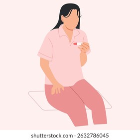 The woman sits staring at the pregnancy test result that shows she is pregnant.