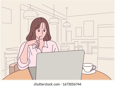 A woman is sitting at a cafe table and looking at a laptop. She is biting a pencil. hand drawn style vector design illustrations. 