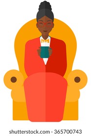 Woman sitting in chair with cup of tea.