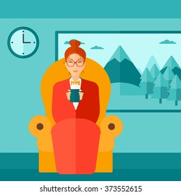 Woman sitting in chair with cup of tea.
