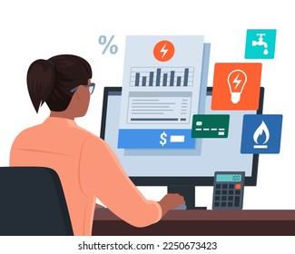 Woman sitting at desk and paying utility bills online using her computer