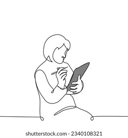 woman sitting with digital tablet or graphics tablet holding stylus in right hand - one line art vector. the concept of taking notes on a tablet, digital artist