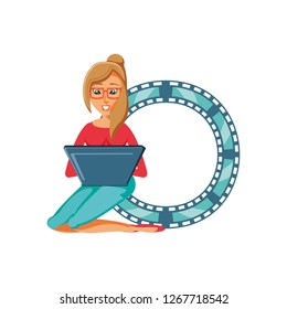 woman sitting with laptop and video tape