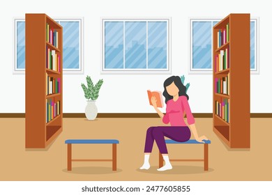 A woman is sitting in a library chair reading a book