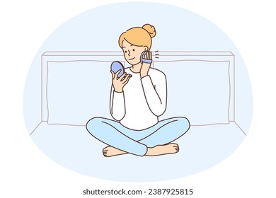Woman sitting on bed at home doing makeup. Happy female enjoy beauty routine in bedroom. Cosmetics and skincare concept. Vector illustration.