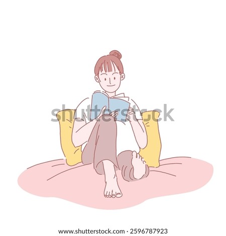 A woman sitting on a bed reading a book