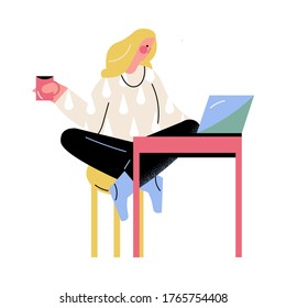 Woman sitting on chair with cup of tea and working from home at laptop