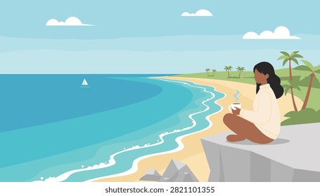 Woman sitting on a cliff overlooking the ocean with a cup of hot coffee.