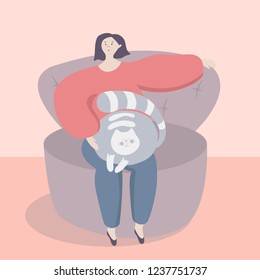 Woman sitting on a cosy sofa and holding grey cat on her knees. Lady and her animal pet. Cat lying on girl's knees and smiling.