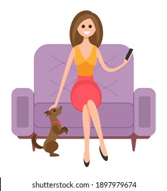 Woman is sitting on the couch and petting the dog. Beautiful girl with a phone in her hands. Female character is resting and spending time at home with her pet. The puppy stands on its hind legs