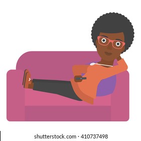 Woman sitting on the couch with remote control.