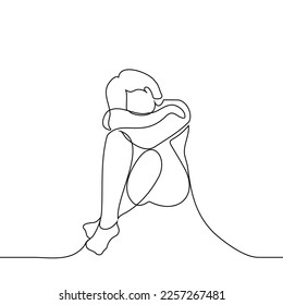 woman sitting on the floor cowering alone - one line drawing vector. concept sad, miss someone, depression, loneliness, mental problems