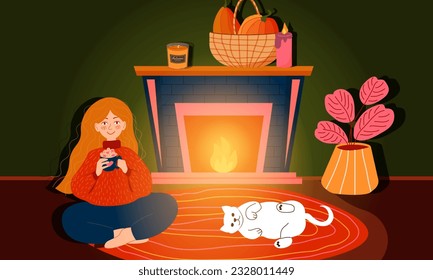 Woman sitting on floor near fireplace at home with coffee in hands, cat is laying. Cozy evening time by fireside of girl and cat. Autumn concept for banner,