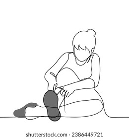 woman sitting on the floor ties a lace on a sneaker - one line art vector. concept putting on shoes, trying on shoes, tying shoelaces training