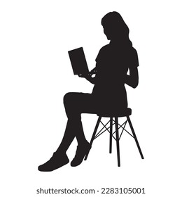 Woman sitting on office chair working with laptop full length silhouette.