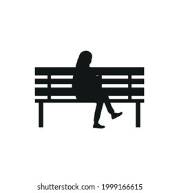 woman sitting on park bench with laptop