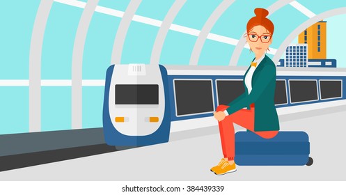 Woman sitting on railway platform.