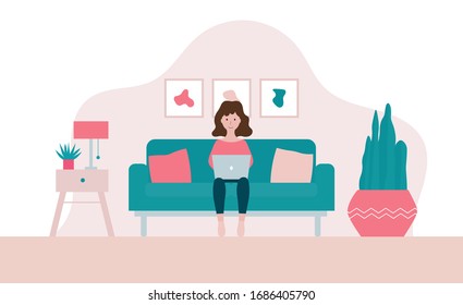 Woman sitting on a sofa with laptop  in her living room in period of self isolation and social distancing during Covid-19 virus epidemic. Stay home concept. Freelance or studying concept.