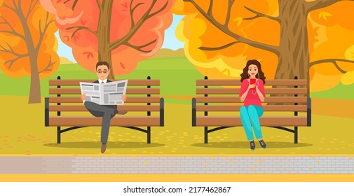 Woman sitting in park on brench holds smartphone in her hand. Casual lady in headpones listening to music and browsing social media on mobile device. Man read news paper in autumn park