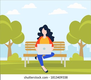 woman sitting relaxed on a lawn chair using a laptop