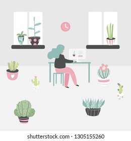 Woman sitting in room surrounded with cactus