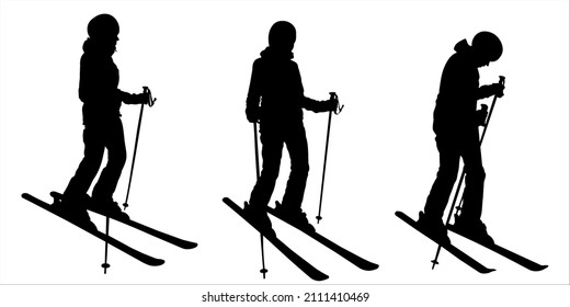 Woman skier. Girl in a ski suit with ski sticks in her hands and skis on her feet. The skier stands half sideways, bending his knee. Winter sports. Female black silhouette isolated on white background