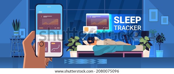 woman sleeping\
in bed with electronic smart watch app tracker on hand quality and\
quantity sleep control\
concept