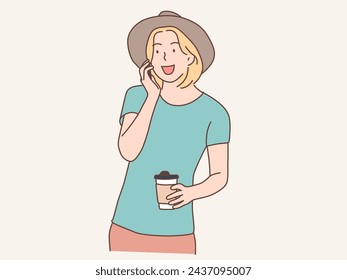 woman with smartphone and carrying coffee