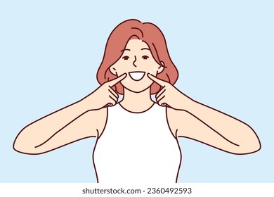 Woman smile and shows off white teeth and points fingers at mouth to invite people to dental clinic. Positive girl is trained to make big smile to appear friendly for successful sales