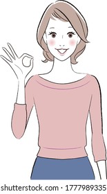 woman smiling showing ok hand sign